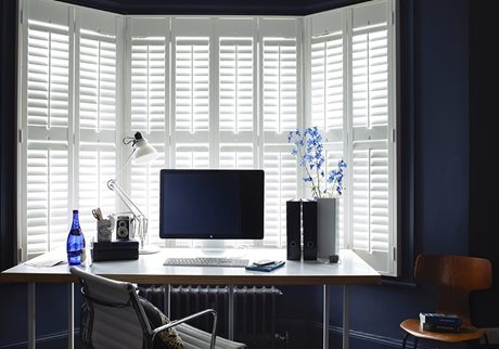 white shutters in navy blue home office
